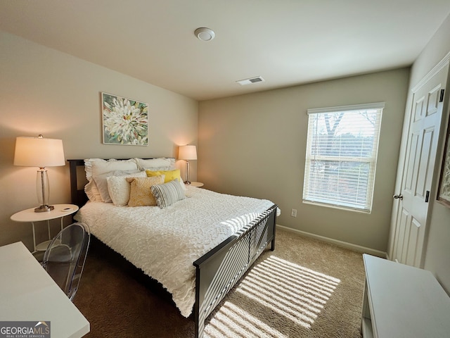 carpeted bedroom with visible vents and baseboards