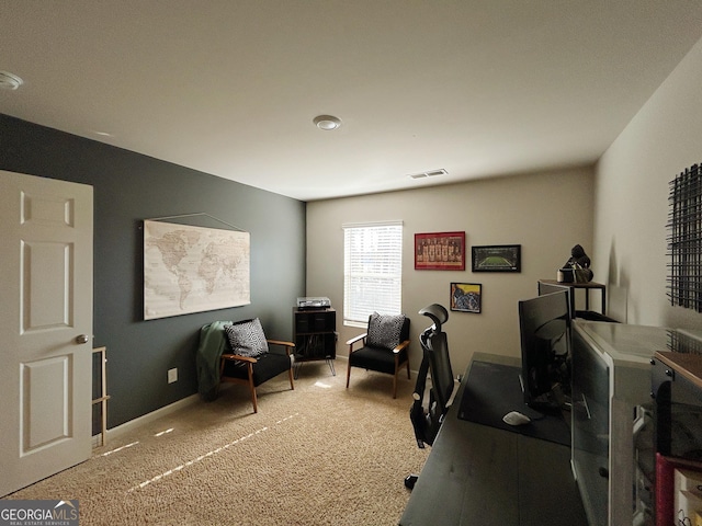 office space featuring light carpet, visible vents, and baseboards