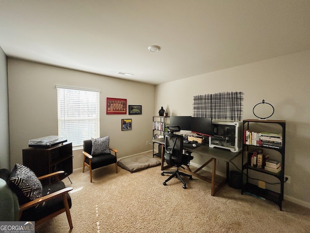 carpeted office space with visible vents and baseboards