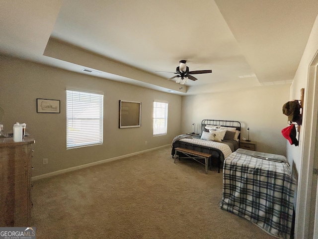 bedroom with baseboards, a raised ceiling, visible vents, and carpet flooring