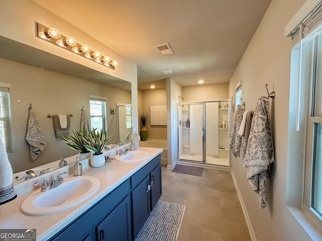 bathroom featuring a sink, visible vents, double vanity, and a shower stall