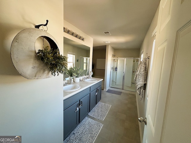 bathroom with tile patterned floors, visible vents, a stall shower, a sink, and double vanity