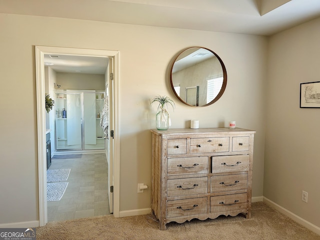 interior space featuring light carpet and baseboards