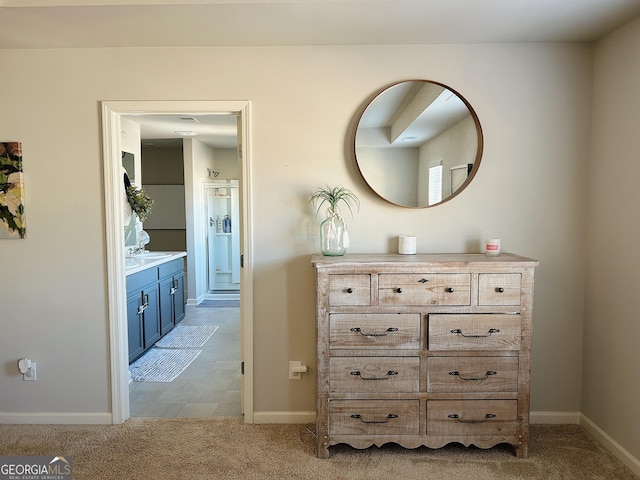 hallway featuring baseboards and carpet