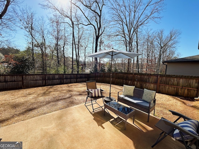 view of patio with an outdoor living space and a fenced backyard