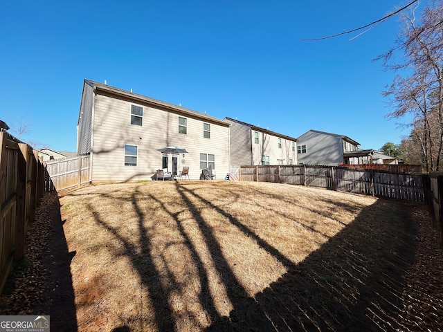 back of property with a fenced backyard