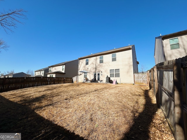 back of property with a fenced backyard