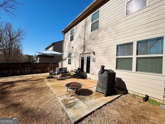 back of house with a patio area, fence, and a fire pit