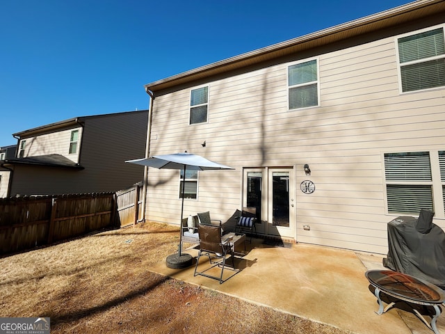 back of house with a patio and fence