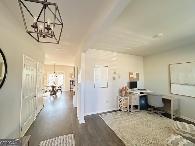 office space featuring dark wood finished floors, a notable chandelier, and baseboards