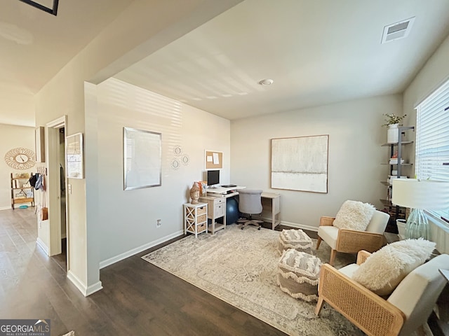 office area featuring visible vents, baseboards, and wood finished floors