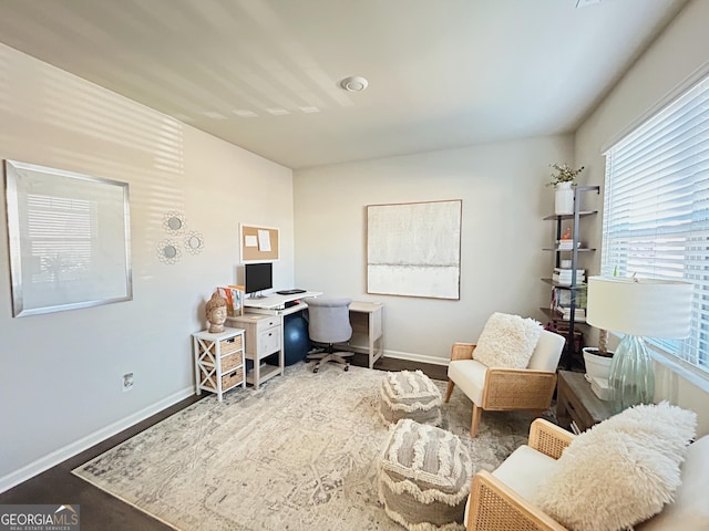 office area with baseboards and wood finished floors