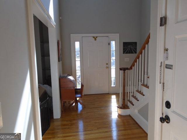 entrance foyer featuring stairway and light wood-type flooring