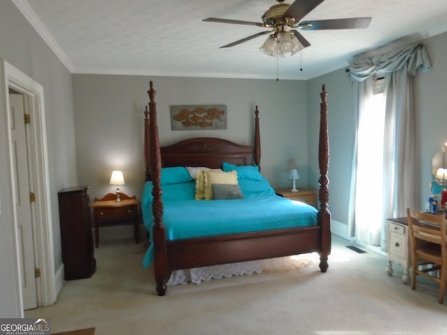 carpeted bedroom with ceiling fan, visible vents, and ornamental molding