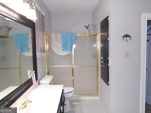 full bathroom featuring tile patterned floors, a shower stall, toilet, and vanity