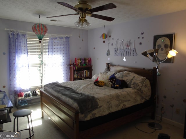 bedroom with visible vents, a textured ceiling, and ceiling fan