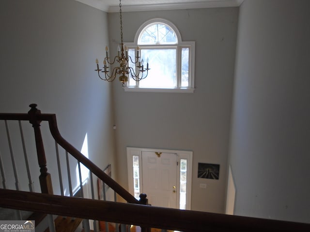 entrance foyer featuring stairs and a chandelier