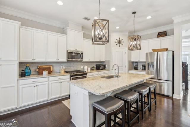 kitchen with visible vents, ornamental molding, stainless steel appliances, and a sink