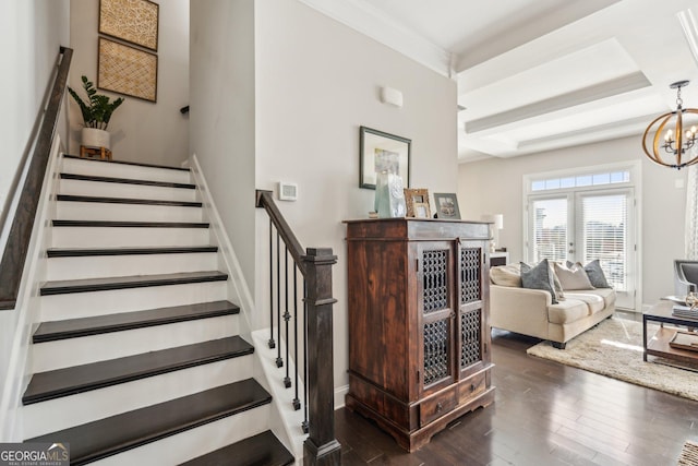 stairs with french doors, baseboards, an inviting chandelier, and wood finished floors