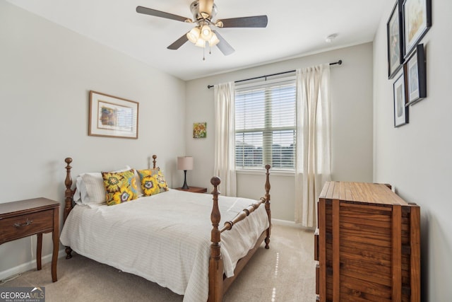 bedroom with light colored carpet, a ceiling fan, and baseboards