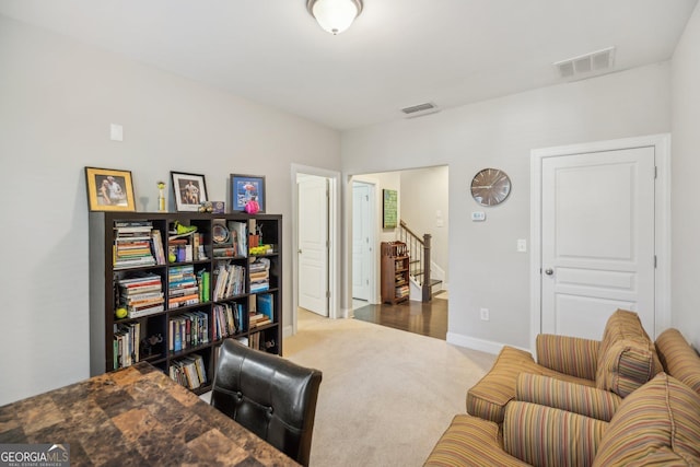 carpeted home office with visible vents and baseboards