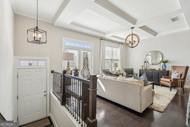 living room with visible vents, coffered ceiling, an inviting chandelier, dark wood-style flooring, and beamed ceiling