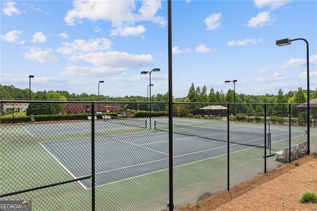 view of tennis court with fence