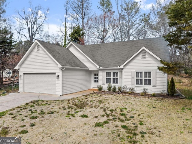 single story home with a front lawn, concrete driveway, and an attached garage