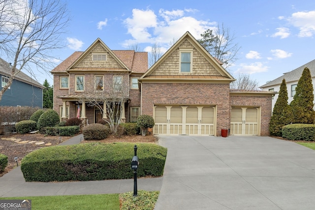 craftsman-style home featuring brick siding, driveway, and a garage