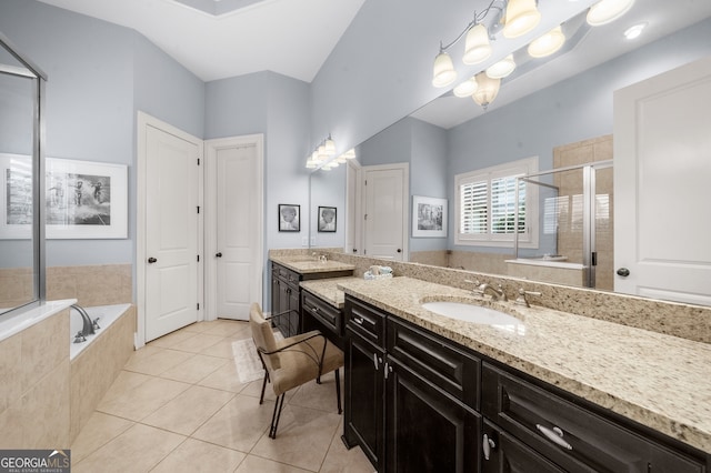 bathroom with tile patterned floors, a garden tub, a stall shower, and vanity