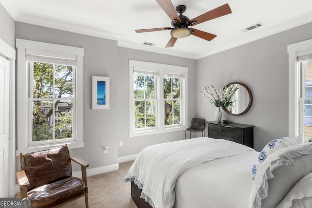 bedroom with crown molding, multiple windows, and light carpet