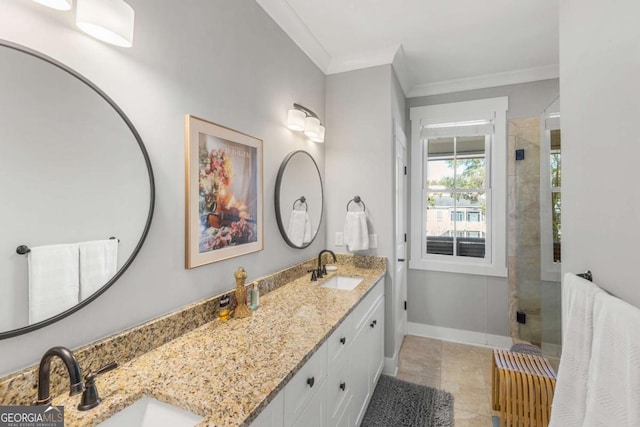 full bath featuring ornamental molding, a stall shower, baseboards, and a sink