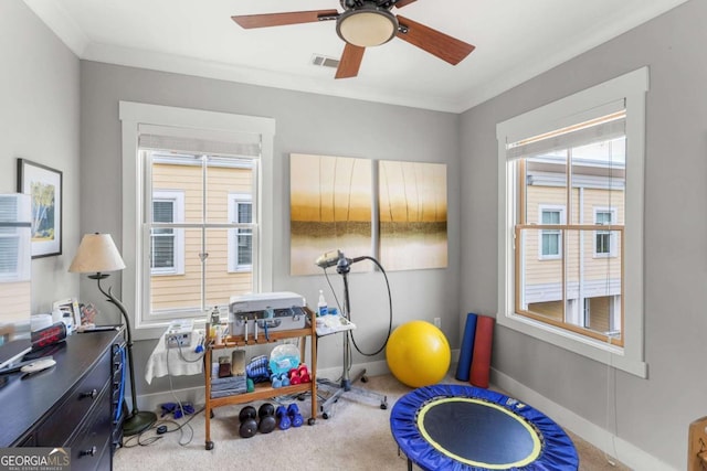 interior space featuring visible vents, baseboards, carpet floors, and crown molding