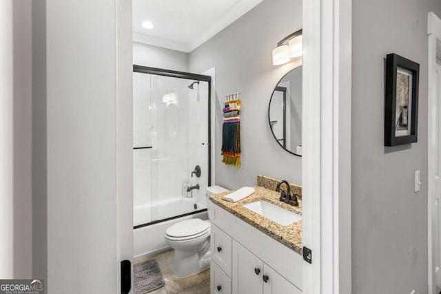 bathroom with combined bath / shower with glass door, toilet, and vanity