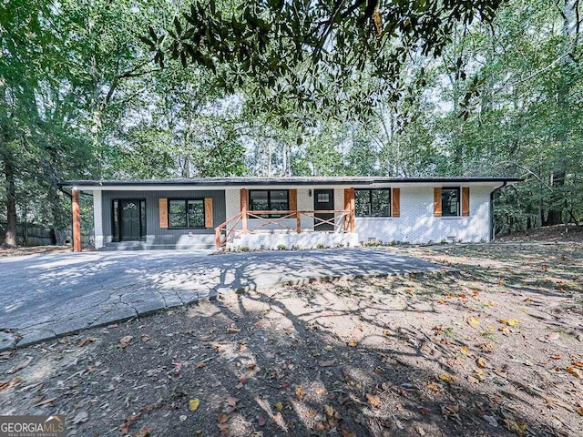 view of front of property featuring brick siding and covered porch