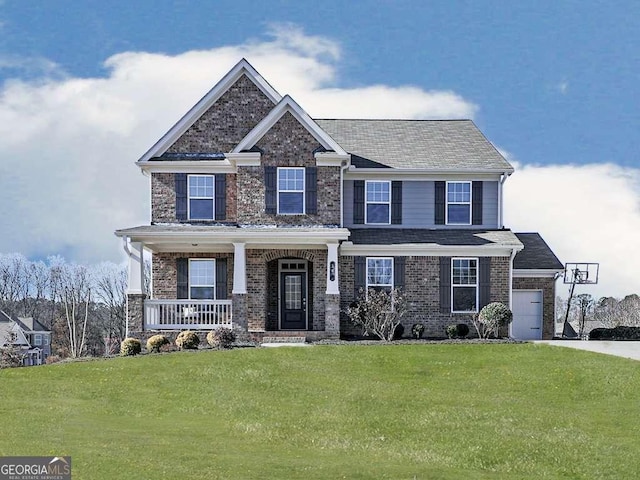 craftsman house featuring brick siding, a porch, concrete driveway, and a front lawn