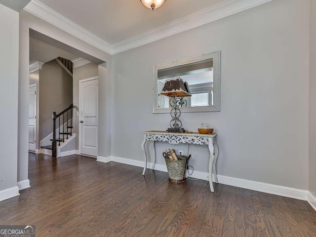 interior space featuring baseboards, wood finished floors, stairs, and crown molding