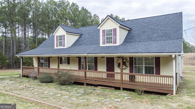 view of front of house featuring covered porch and a shingled roof