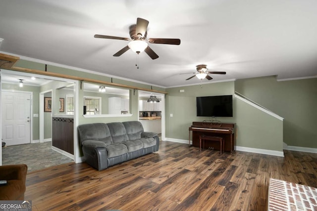 living area featuring a ceiling fan, wood finished floors, baseboards, and ornamental molding