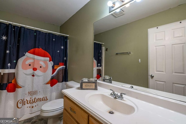 bathroom with vanity, curtained shower, toilet, and visible vents