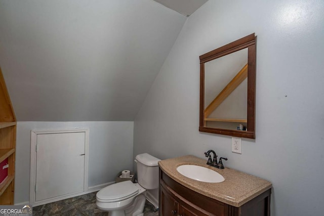 half bath featuring toilet, vanity, and lofted ceiling