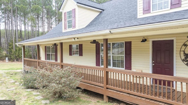 view of front of property with roof with shingles and a porch