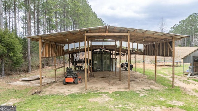 view of outbuilding with a carport and an outbuilding