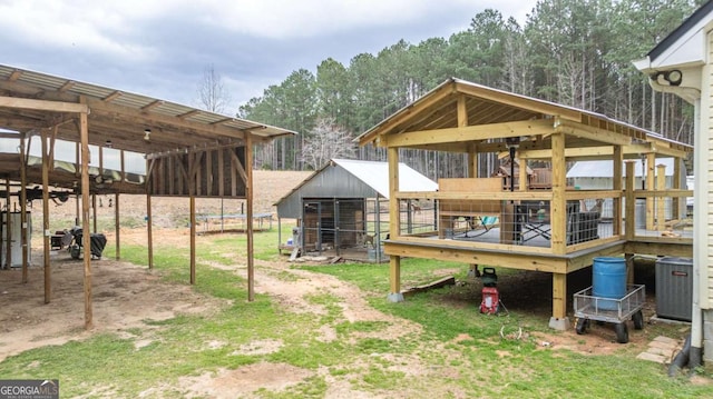 view of yard with an exterior structure, an outbuilding, and central AC unit