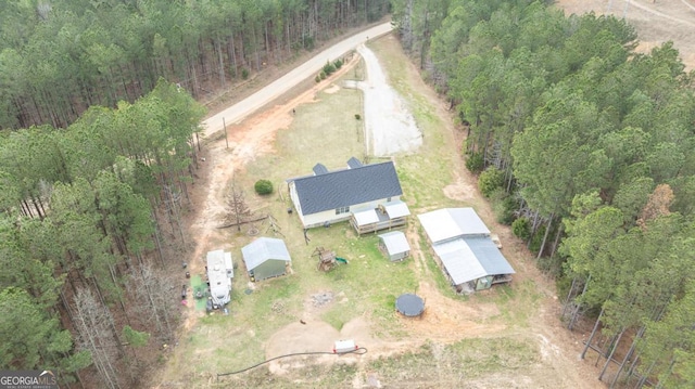 birds eye view of property featuring a view of trees