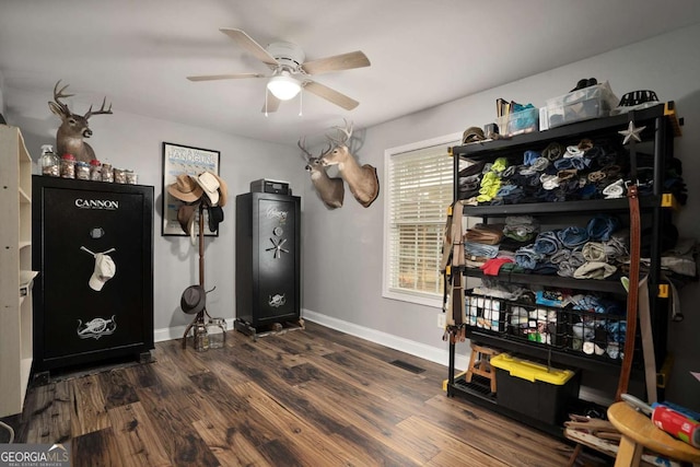 interior space featuring visible vents, baseboards, wood finished floors, and a ceiling fan