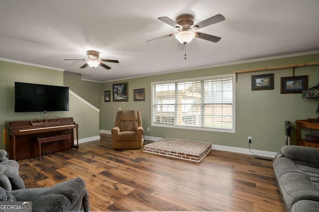 living room with visible vents, crown molding, baseboards, wood finished floors, and a ceiling fan