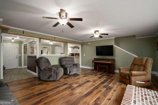 living room with baseboards, wood finished floors, and crown molding