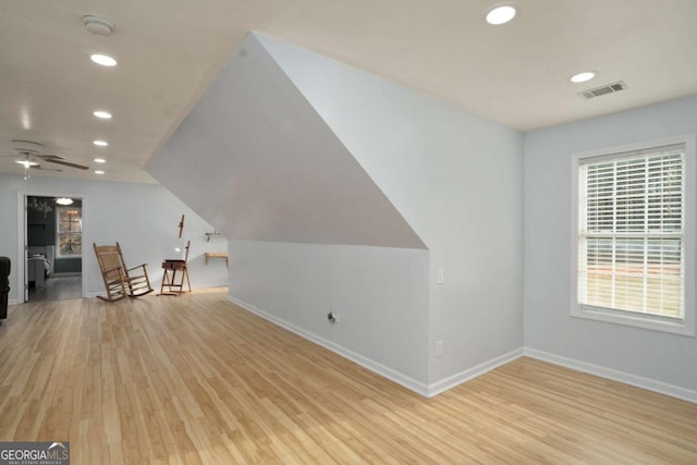 unfurnished room featuring baseboards, visible vents, lofted ceiling, recessed lighting, and light wood-type flooring