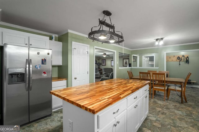 kitchen with ornamental molding, wooden counters, and stainless steel fridge with ice dispenser